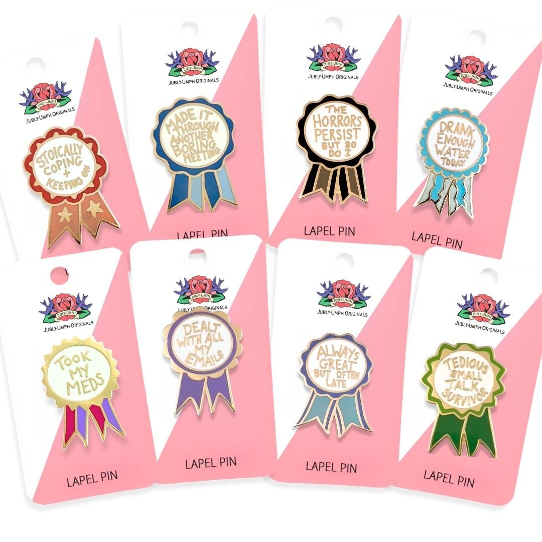 Set of eight lapel pins in packaging with humorous sayings.