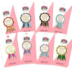 Set of eight lapel pins in packaging with humorous sayings.