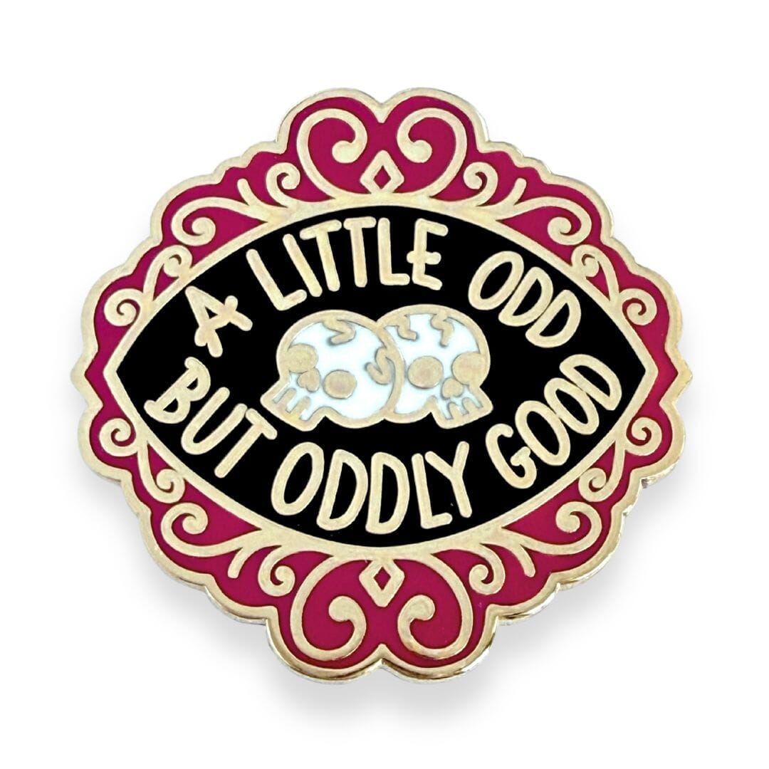 Pin with 'A Little Odd But Oddly Good' text and skull design on a white background