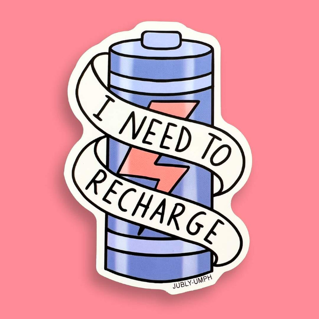 The vinyl sticker is in the shape of a battery against a pink background. The sticker reads I Need To Recharge.