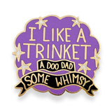 Purple and gold enamel pin with I like a trinket, a doo-dad, some whimsy design on a cloud background