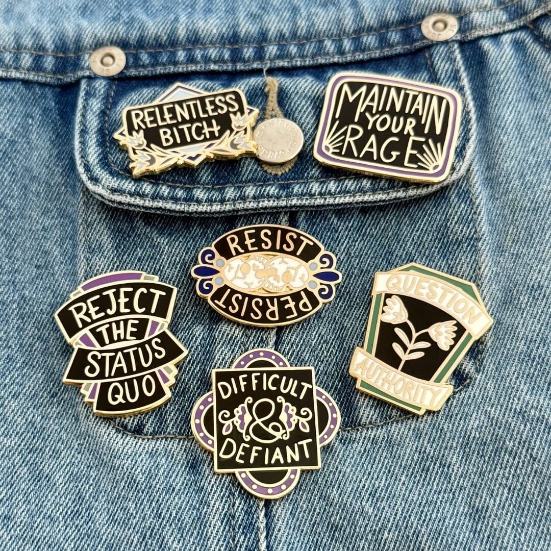 Collection of politically themed pins on a denim jacket