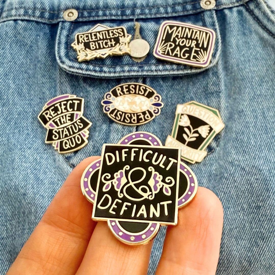 Collection of punk-style pins on a denim jacket