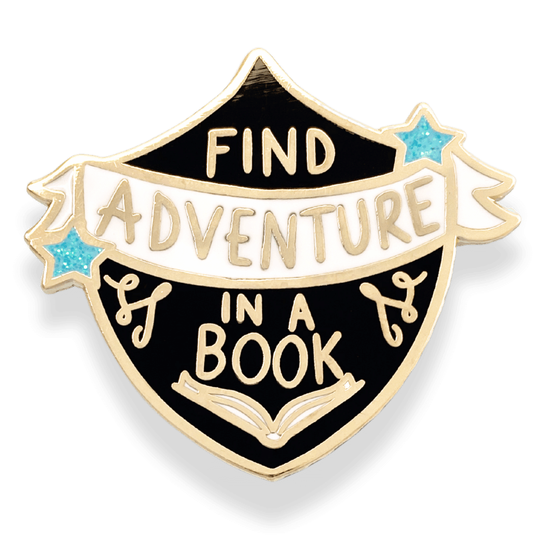 A gold-backed, hard enamel lapel pin with the text 'FIND ADVENTURE IN A BOOK' on a white banner, surrounded by a black shield-shaped background with a blue star on the left side.