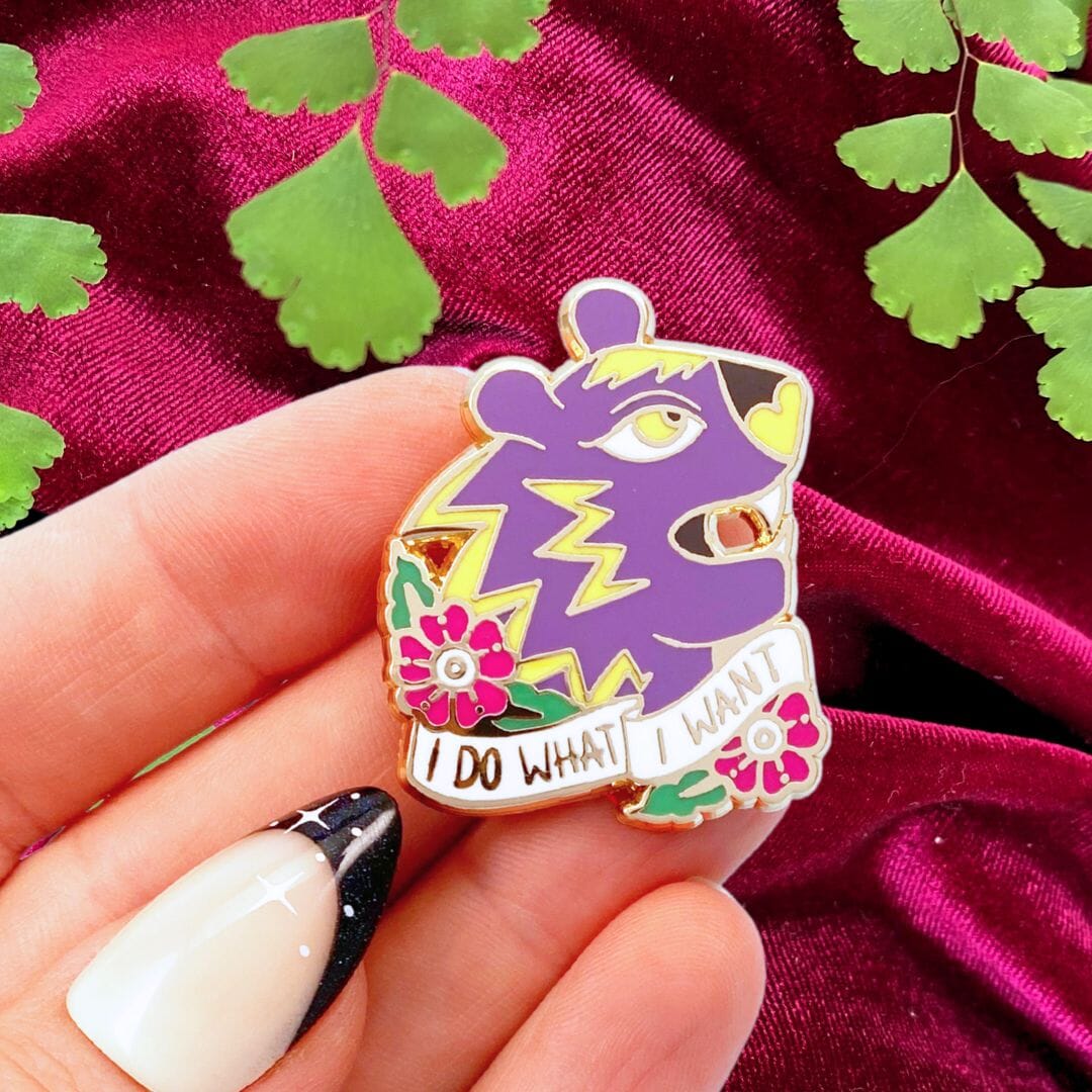 mildly intimidating pin being held with plant and velvet red background