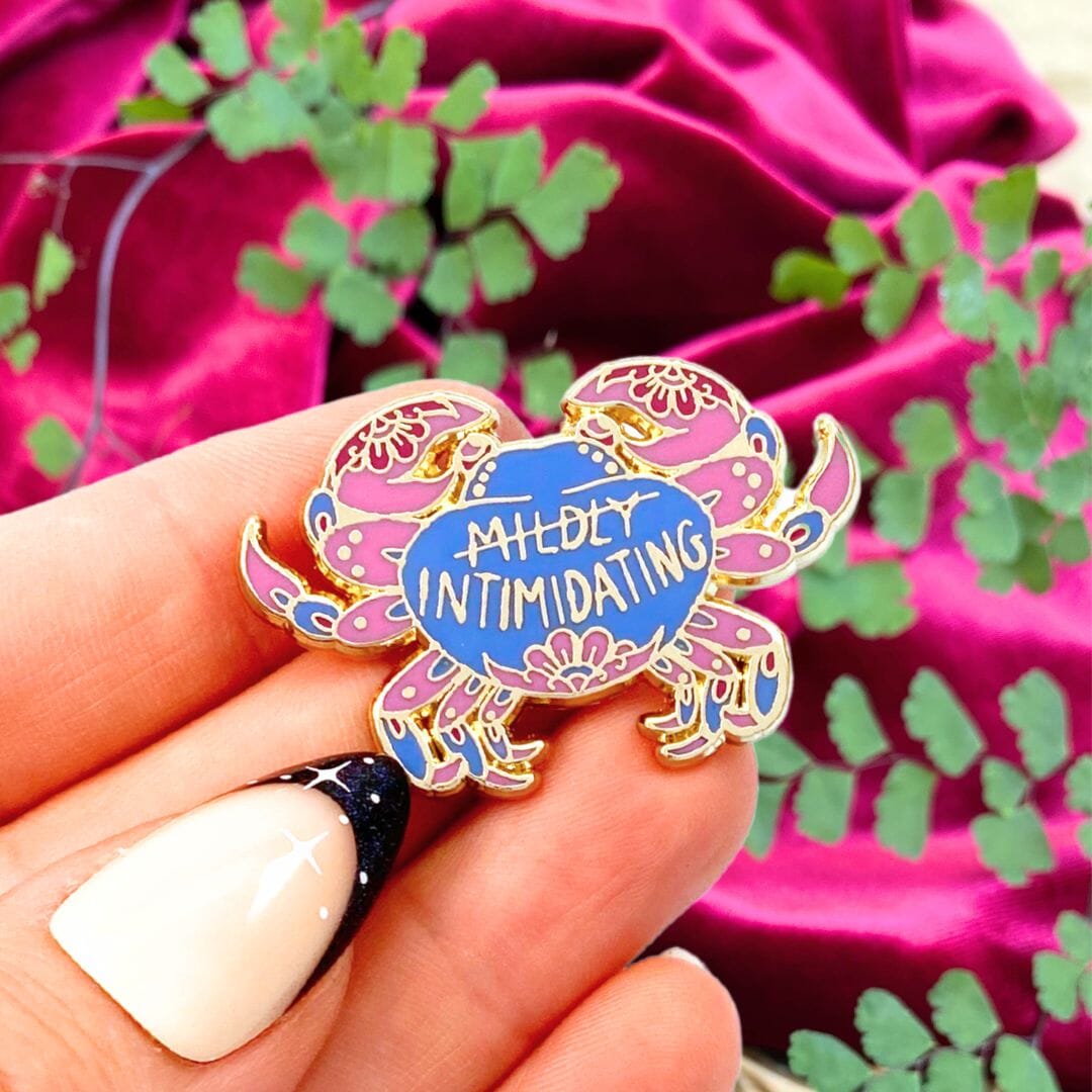 Mildly intimidating pin being held with plant and velvet red background