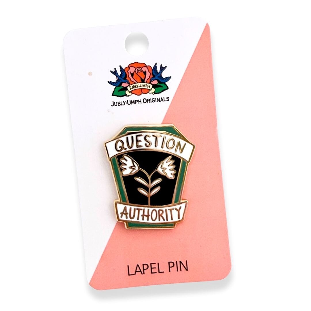 Lapel pin with 'Question Authority' text on a pink card, featuring Jubly-Umph Originals branding.