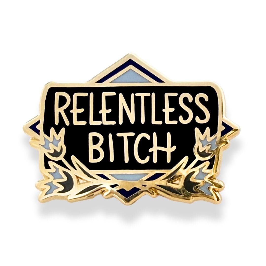 Pin with 'RELENTLESS BITCH' text on a black background with gold and blue accents