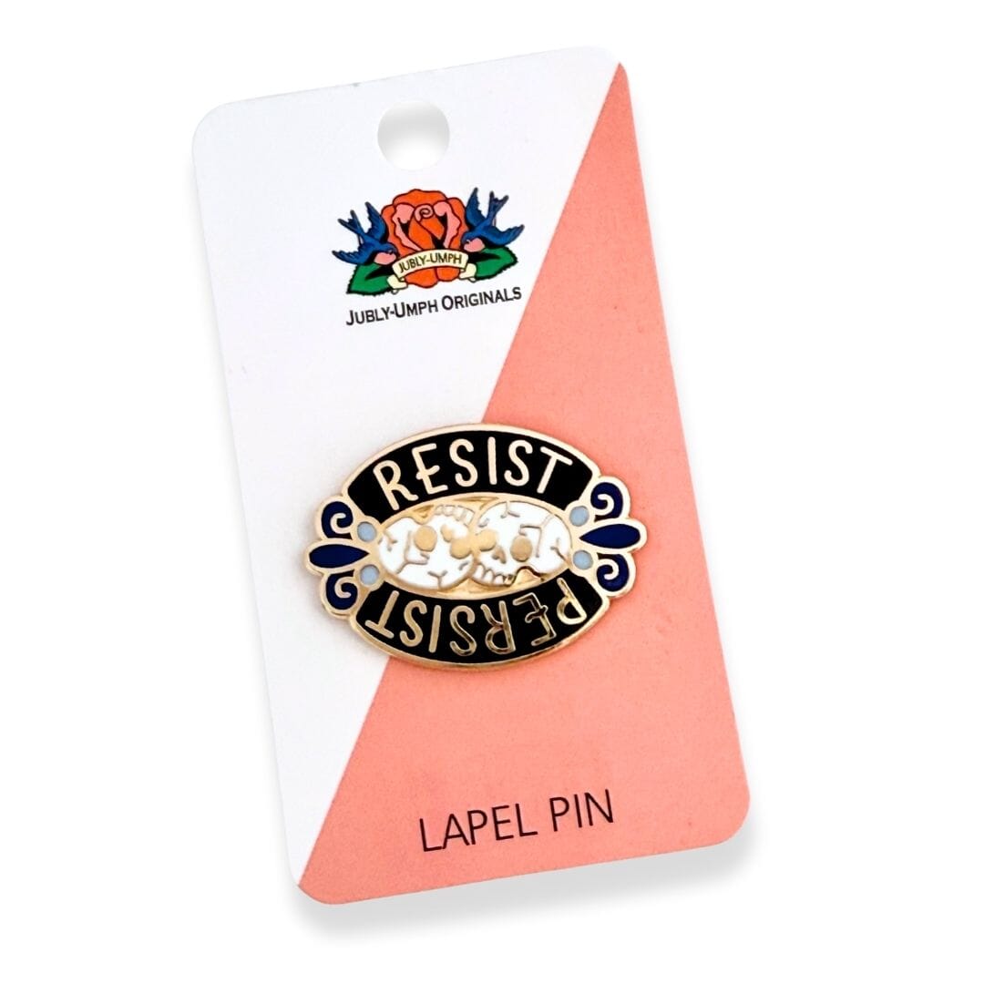Lapel pin with 'Resist Persist' text on a card with Jubly-Umph Originals branding.