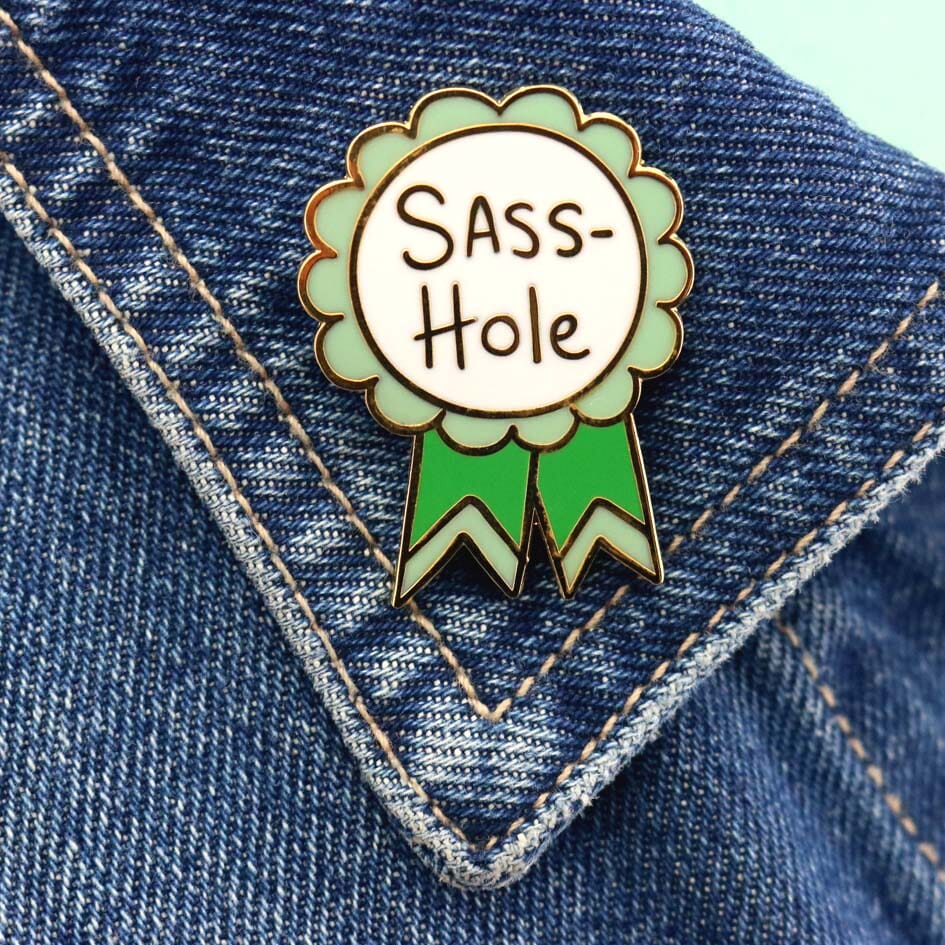 Sass-Hole Lapel Pin on a denim jacket lapel