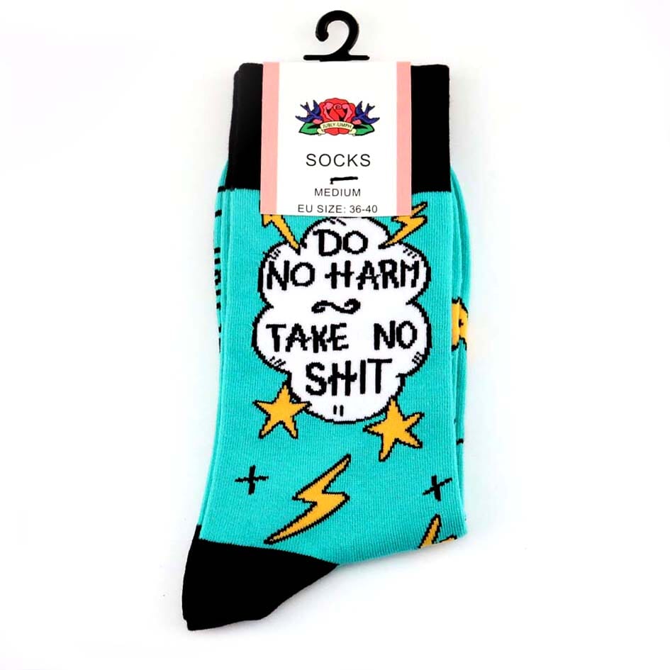 A pair of socks on a white background. The socks are teal and black and read Do No Harm Take No Shit.