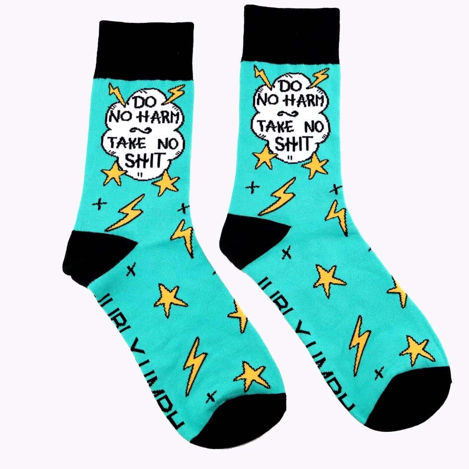 A pair of socks on a white background. The socks are teal and black and read Do No Harm Take No Shit.