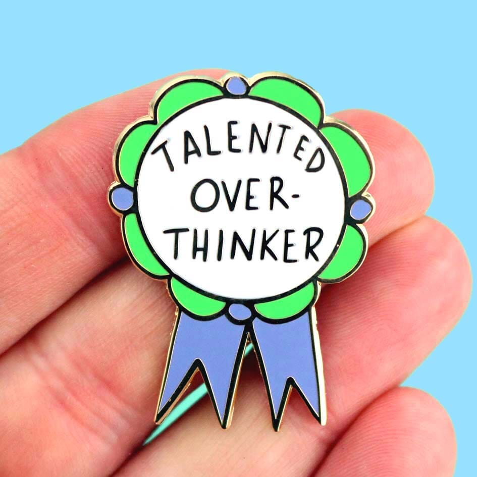 Talented Over Thinker Lapel Pin held in the hand