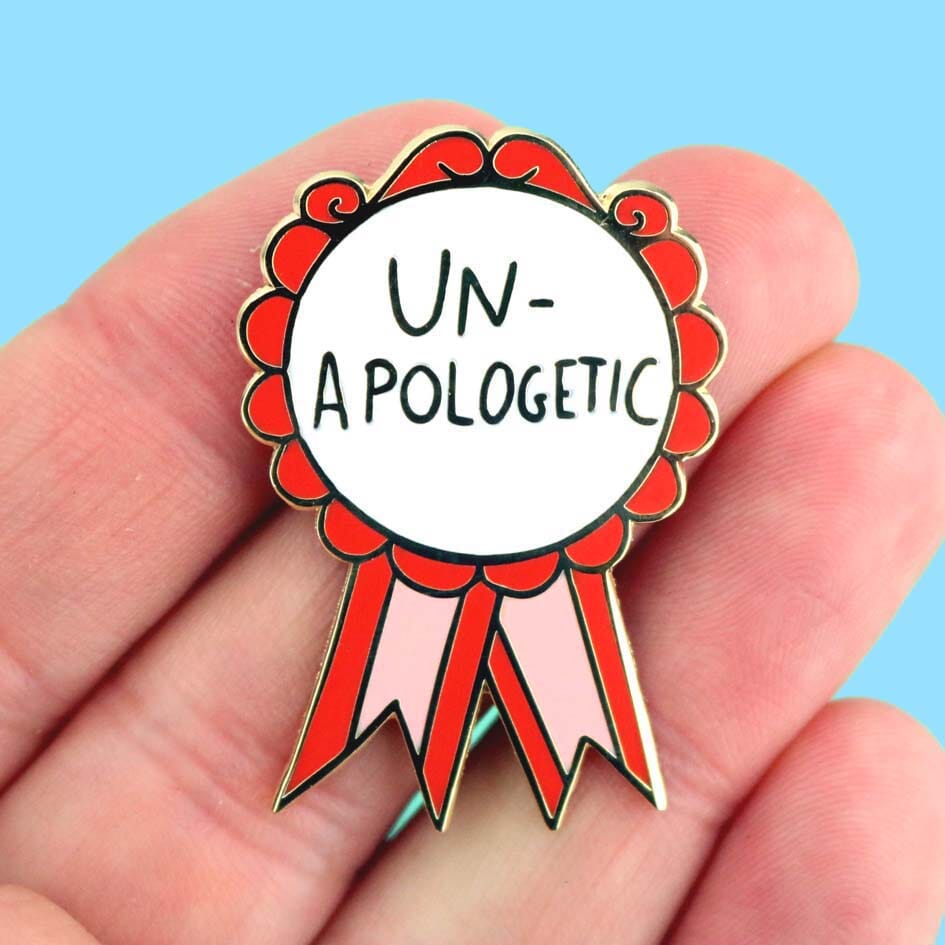 Un-Apologetic Lapel Pin held in hand