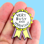 Very Busy and Important Lapel Pin held in hand